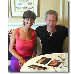 John McEnroe signs autographs and meets a guest at Wimbledon